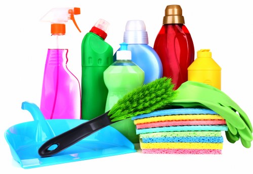 Carpet cleaning team applying health and safety practices in a clean indoor setting